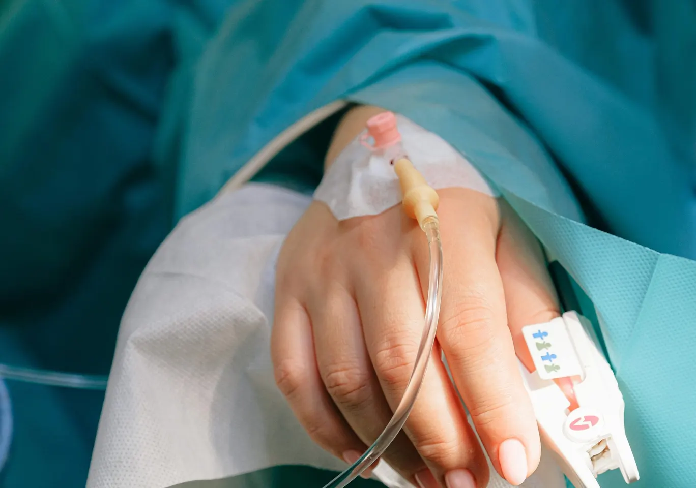 Detoks alkoholowy Radziejów: dłoń z wenflonem i pulsoksymetrem pod nadzorem